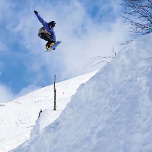 Girardi Brolinmawejje jumping on snowboard