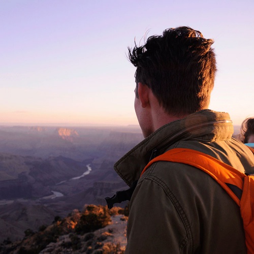 student overlooking the grand canyon