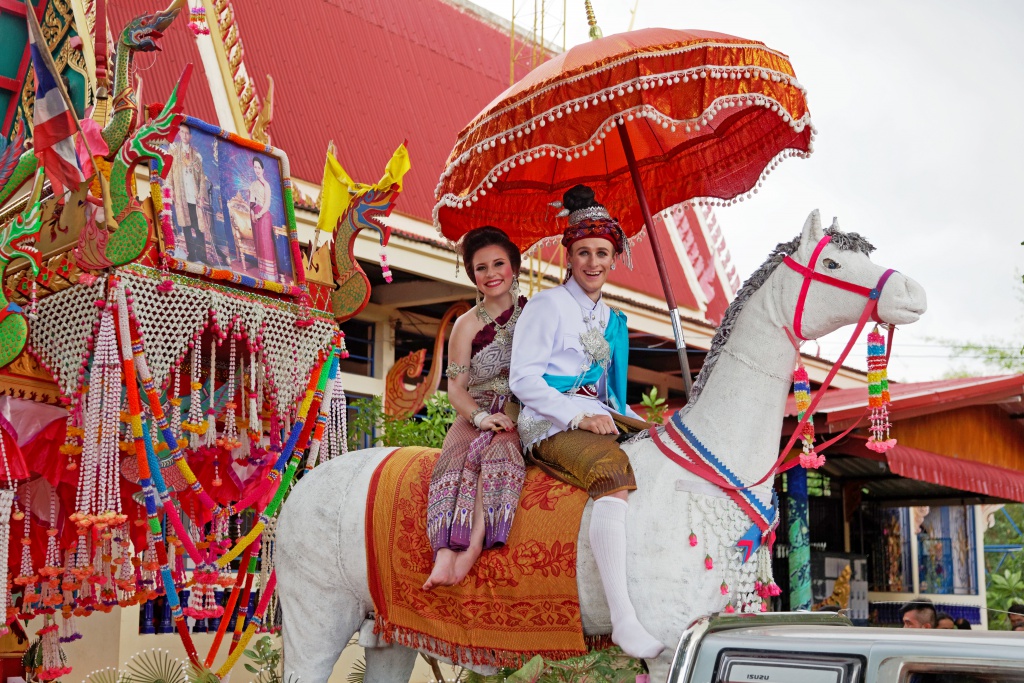 couple on decorative fake horse in Thailand