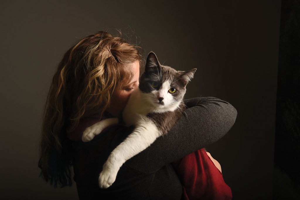 female hugging her cat