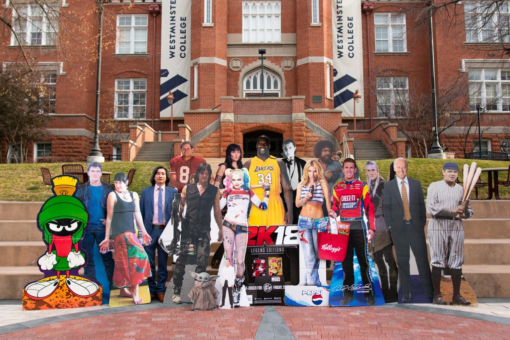 Nghia Nguyen and cardboard cut outs in front of Converse building