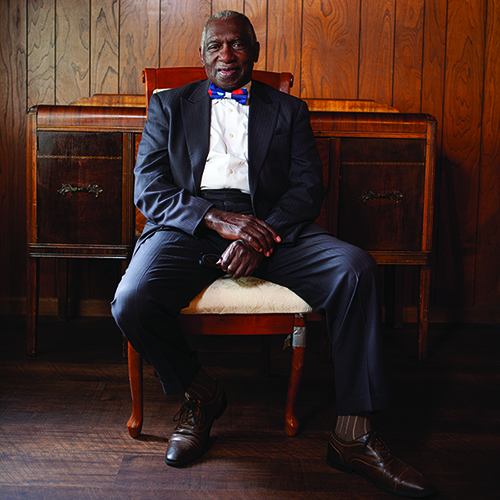 Reverend France A. Davis sitting on chair in suit